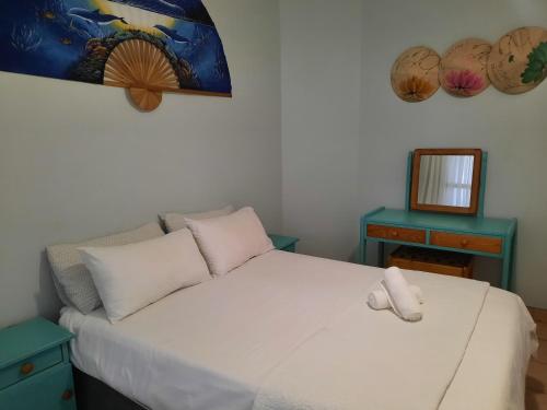 a bedroom with a white bed and a mirror at Sea View Holiday Flat - 16 La Luce Margate in Margate