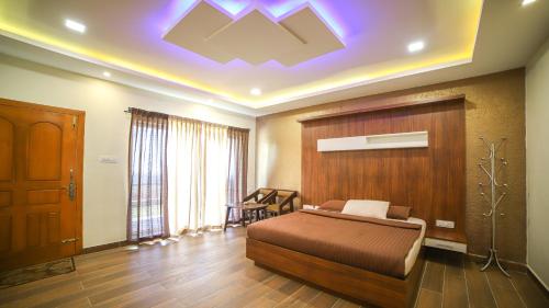 a bedroom with a bed with a wooden headboard at Aira Residency Kothagiri by Lexstays in Kotagiri