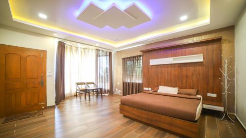 a bedroom with a bed in a room with a ceiling at Aira Residency Kothagiri by Lexstays in Kotagiri