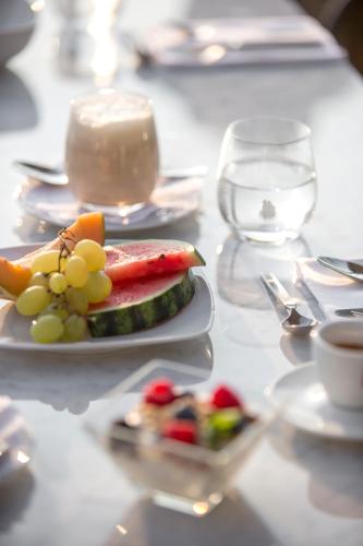 a plate of fruit and vegetables on a table at Villa Maria Boutique Hotel in Cannobio