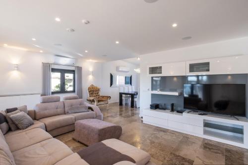 a living room with a couch and a large television at Belo Horizonte by DreamPlaces in Porches