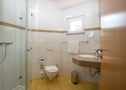 y baño con aseo, lavabo y ducha. en Rebhan's Klassik, en Stockheim
