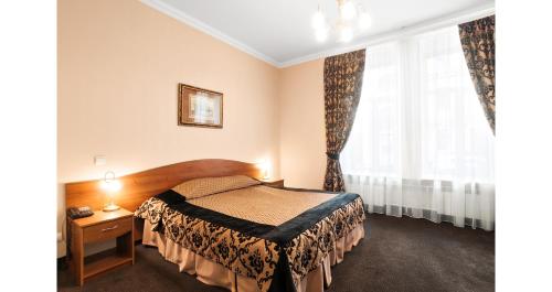 a hotel room with a bed and a window at Noteburg in Saint Petersburg