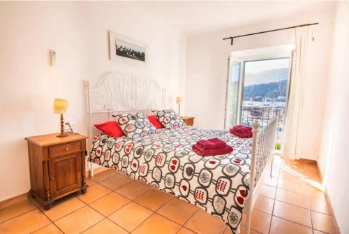 a bedroom with a bed and a large window at Ca Na Magda in Port de Soller