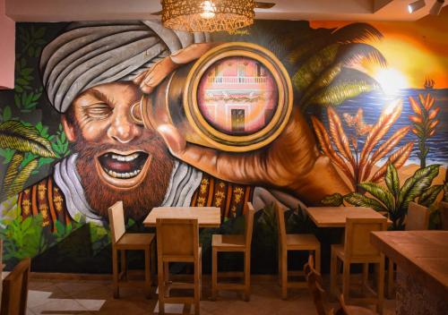a mural of a man holding a barrel in a restaurant at Casa Zahri Boutique Hostel in Cartagena de Indias