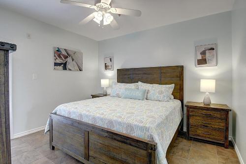 a bedroom with a bed and a ceiling fan at Shorts Story in Port Aransas