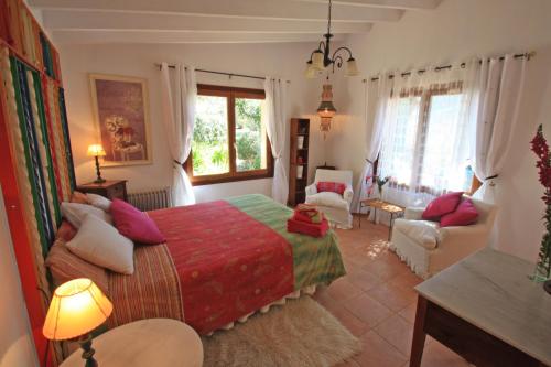 a bedroom with a bed and a living room at Can Bac in Sóller