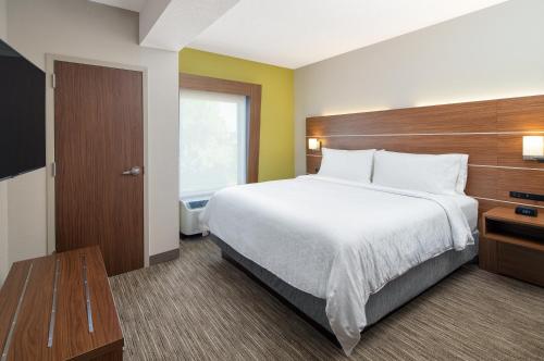 a hotel room with a large bed and a window at Holiday Inn Express Statesboro by IHG in Statesboro