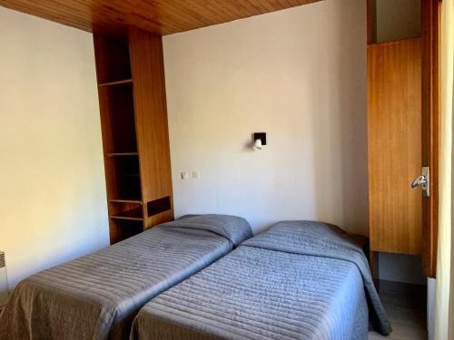 a bedroom with two beds in a room at Le Pidanoux in Saint-Julien-du-Verdon