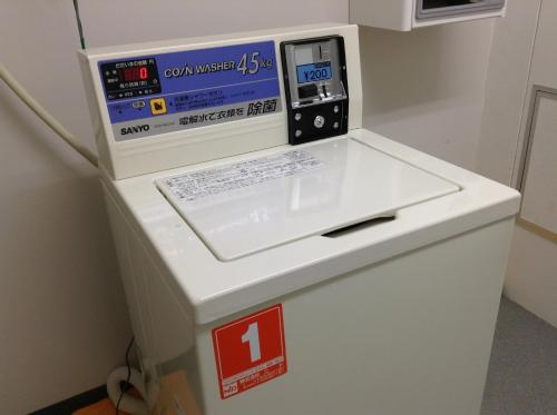 a machine with a box on top of a refrigerator at Hotel Petit Riviere Karuizawa in Karuizawa