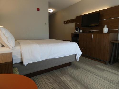 a hotel room with a bed and a flat screen tv at Holiday Inn Express Hotel & Suites Limon I-70/Exit 359 by IHG in Limon