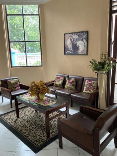 a living room with couches and a coffee table at Hotel Garuda Syariah near Alun Alun Banjarnegara in Wonosobo