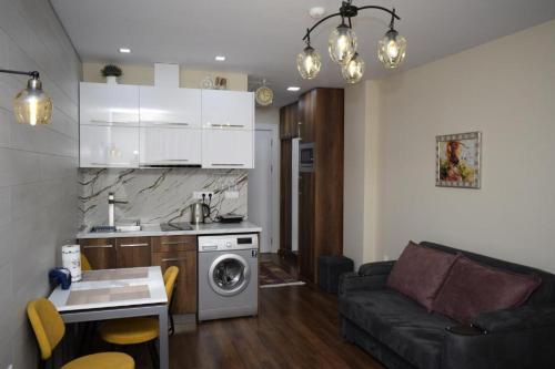 a kitchen and a living room with a couch at New Gudauri, Loft 2 in Gudauri