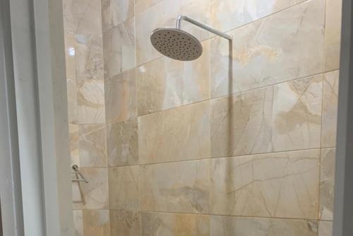 a bathroom with a shower with a glass door at RedDoorz Syariah near Kawasan Simpang Lima Pati in Pati