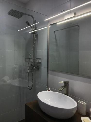 a bathroom with a sink and a shower and a mirror at New Gudauri, Loft 2 in Gudauri