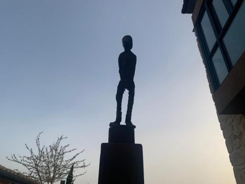 a statue of a man on top of a building at casa rural de un artista en plena naturaleza piscina y parque de esculturas en villarcayo in Villarcayo