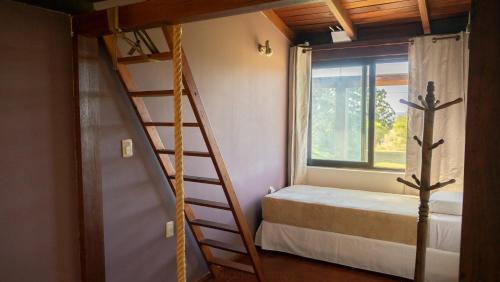 a bedroom with a bunk bed next to a window at CASA LA BORDONA in Rivera
