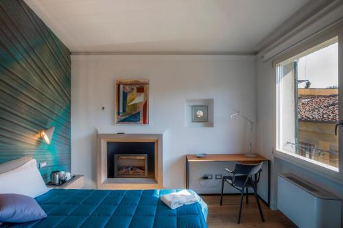 a bedroom with a blue bed and a fireplace at Residenza Benizzi rooms in the heart of Florence in Florence
