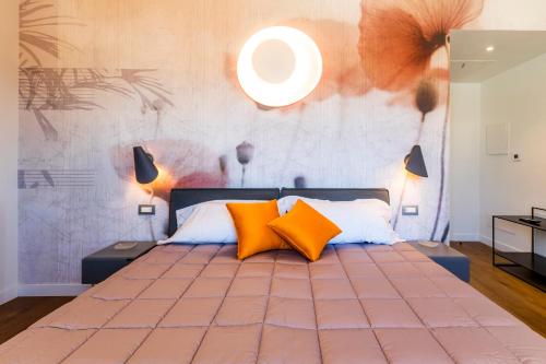 a bedroom with a large bed with orange pillows at Residenza Benizzi rooms in the heart of Florence in Florence