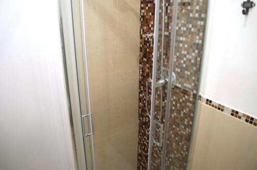 a shower with a glass door in a bathroom at Giramondo in Rapallo