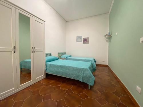 Posteľ alebo postele v izbe v ubytovaní La Casetta di Nonna Anna