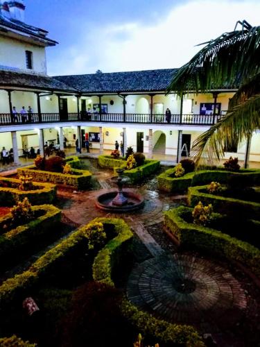 a courtyard with a fountain in the middle of a building at Hotel La Herreria Colonial in Popayan