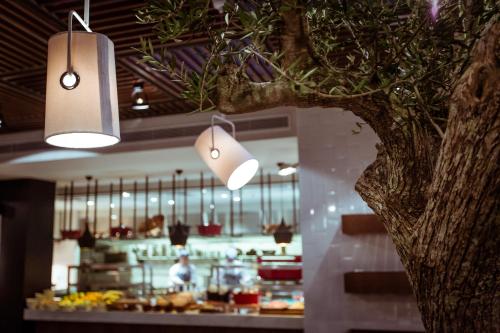 a kitchen with a tree in the middle of a restaurant at Hyatt Centric Montevideo in Montevideo