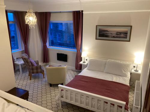 a bedroom with a bed and a living room at Shorelands B&B in Kirkwall
