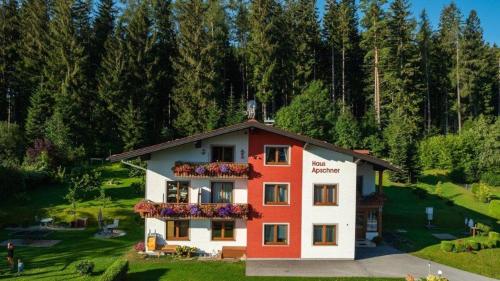 a house with flowers on the balcony of it at Gästehaus Apschner in Sankt Corona am Wechsel