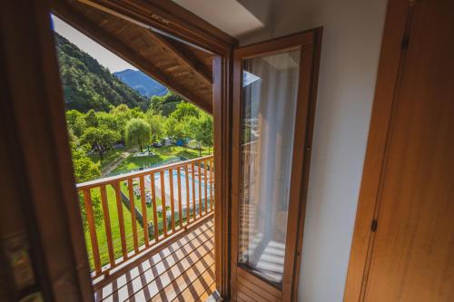 a room with a balcony with a view at Albergo Casavecchia in Tiarno di Sopra