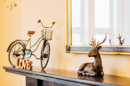 a statue of a deer sitting on a table next to a bike at EveAnna in Alnwick