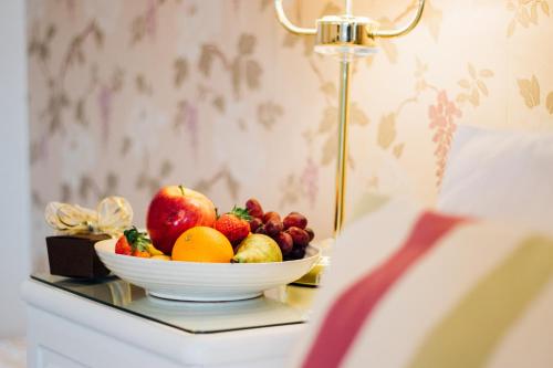 a bowl of fruit on a table with a lamp at EveAnna in Alnwick