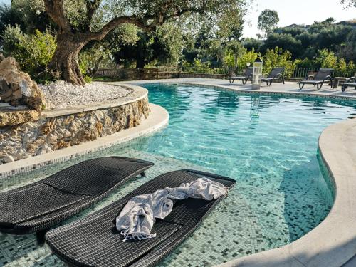 a swimming pool with a towel laying on a raft in the water at Villa Castelletto heated pool jacuzzi in Kipseli