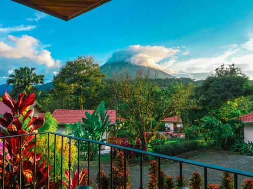 a view from the balcony of a resort with a mountain at Miradas Arenal Hotel & Hotsprings in Fortuna