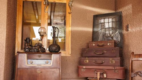 a stack of suitcases in a room with a mirror at La Casa de José in San Pedro de Atacama
