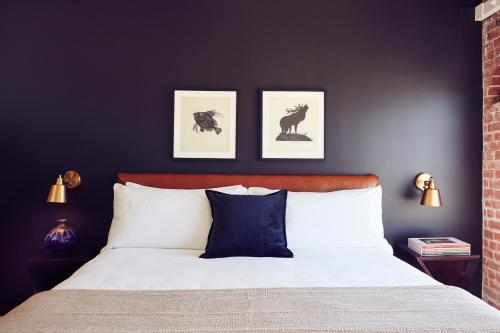 a bedroom with a bed with three pictures on the wall at Venice V Hotel in Los Angeles