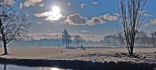 a person riding a bike in a snow covered field at Hotelhuisje Warmenhuizen #E in Warmenhuizen