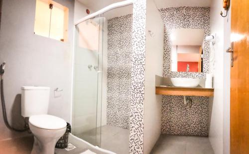 a bathroom with a shower and a toilet and a sink at Pousada Solarium-UNIDADE 2 - HOTEL BOUTIQUE in Guarujá