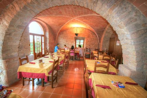 a restaurant with tables and people sitting at them at Hotel Residence Villa Rioddi in Volterra