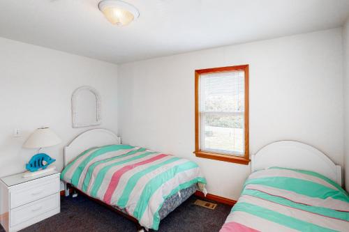 a bedroom with two beds and a window at Devon's Landing #3-PA in Avon