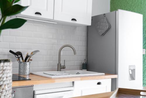 a kitchen with a sink and a counter top at Appartement Barcares Village VUE MER in Le Barcarès