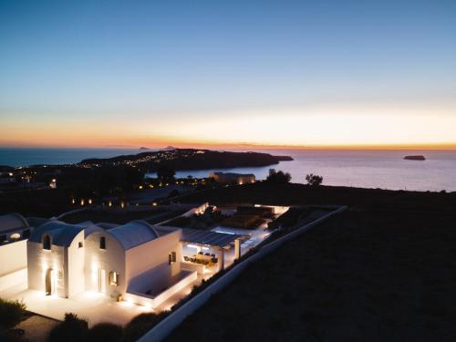 an aerial view of a white building with the ocean in the background at Philosophia Luxury Villa in Megalochori