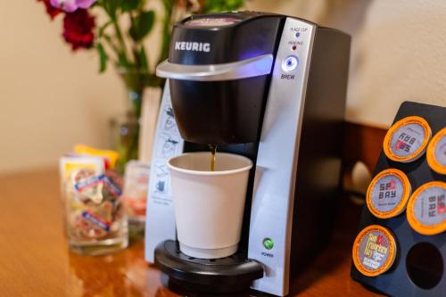 a coffee maker sitting on a table with a cup at Discovery Inn in Friday Harbor