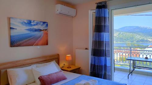 a bedroom with a bed and a window with a view at Blue Lagoon Luxury Apartment A2 in Argostoli