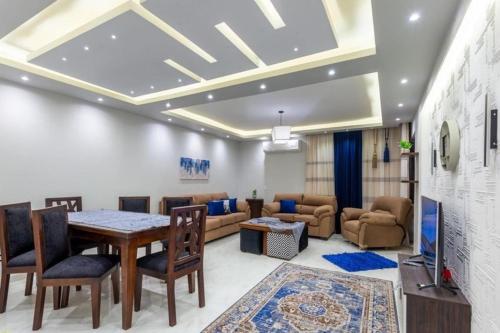 a living room with a table and a couch at New Apartment AlMohandessin near Shehab street in Cairo