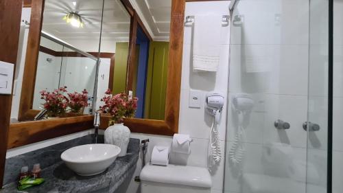 a bathroom with a sink and a shower at Hotel Pousada Casa Grande in Ouro Preto