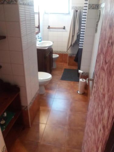 a bathroom with a toilet and a sink at near airport in Las Lagunas