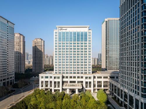a large building in a city with tall buildings at Fairmont Wuhan in Wuhan