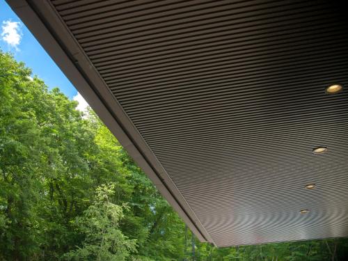 a large metal ceiling of a building with trees at Jizaiso in Nasu