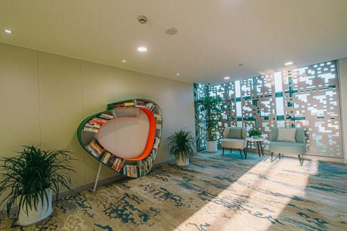 a room with a mirror and a table and chairs at Shanghai JOYFUL YARD Hotel-Free shuttle bus to Pudong Airport and Disneyland in Shanghai
